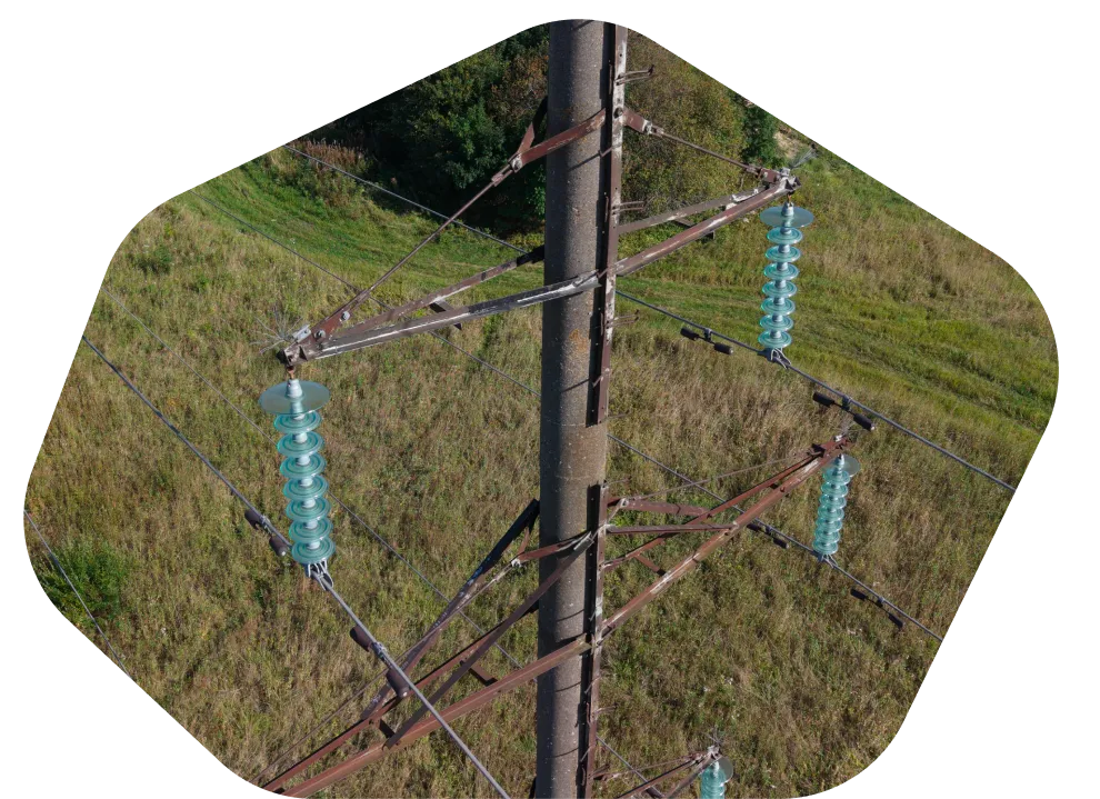 Aerial view of a transmission pylon in open farmland
